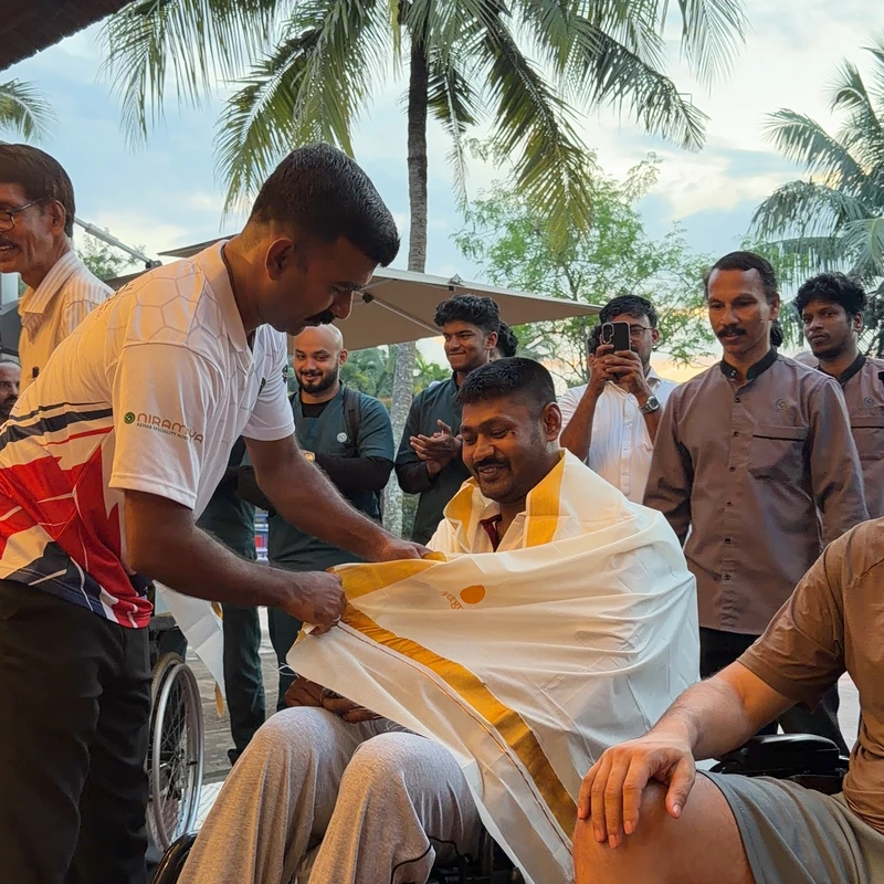 Clinical team honoring patient with traditional ceremonial shawl during discharge milestone